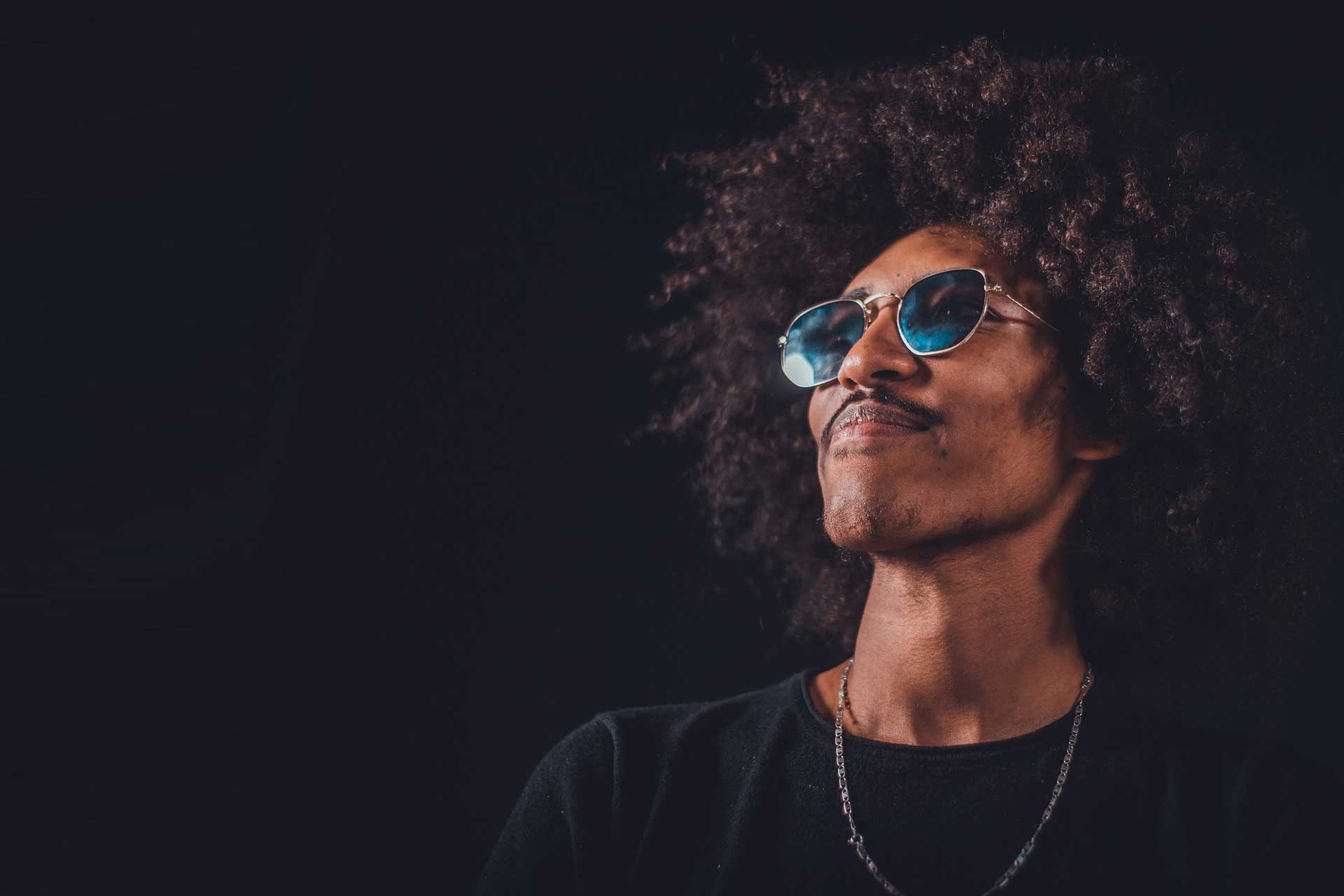 man-in-black-crew-neck-shirt-wearing-blue-sunglasses-3951774