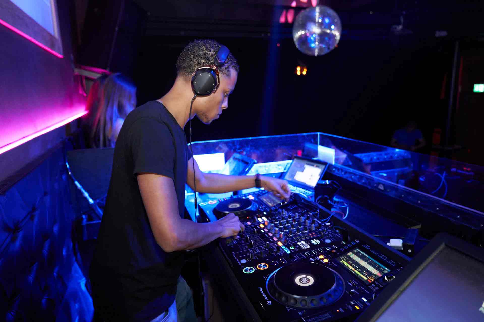 man-wearing-black-crew-neck-shirt-playing-dj-turntable-2123606